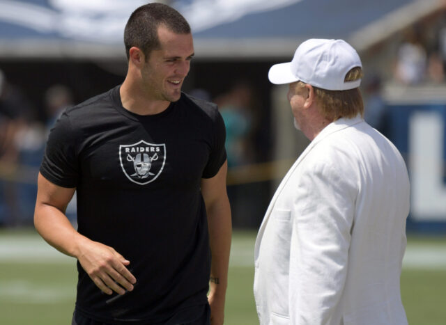 Aug 18, 2018; Los Angeles, CA, USA; Oakland Raiders owner Mark Davis (right) talks with quarterback Derek Carr during a preseason game against the Los Angeles Rams at Los Angeles Memorial Coliseum. Mandatory Credit: Kirby Lee-USA TODAY Sports Mark Davis, Derek Carr, Raiders