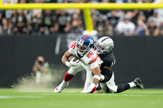 November 5, 2023; Paradise, Nevada, USA; New York Giants running back Saquon Barkley (26) is tackled by Las Vegas Raiders linebacker Jaylon Smith (15) during the first quarter at Allegiant Stadium. Mandatory Credit: Kyle Terada-USA TODAY Sports Jaylon Smith, Raiders, Saquon Barkley, Giants