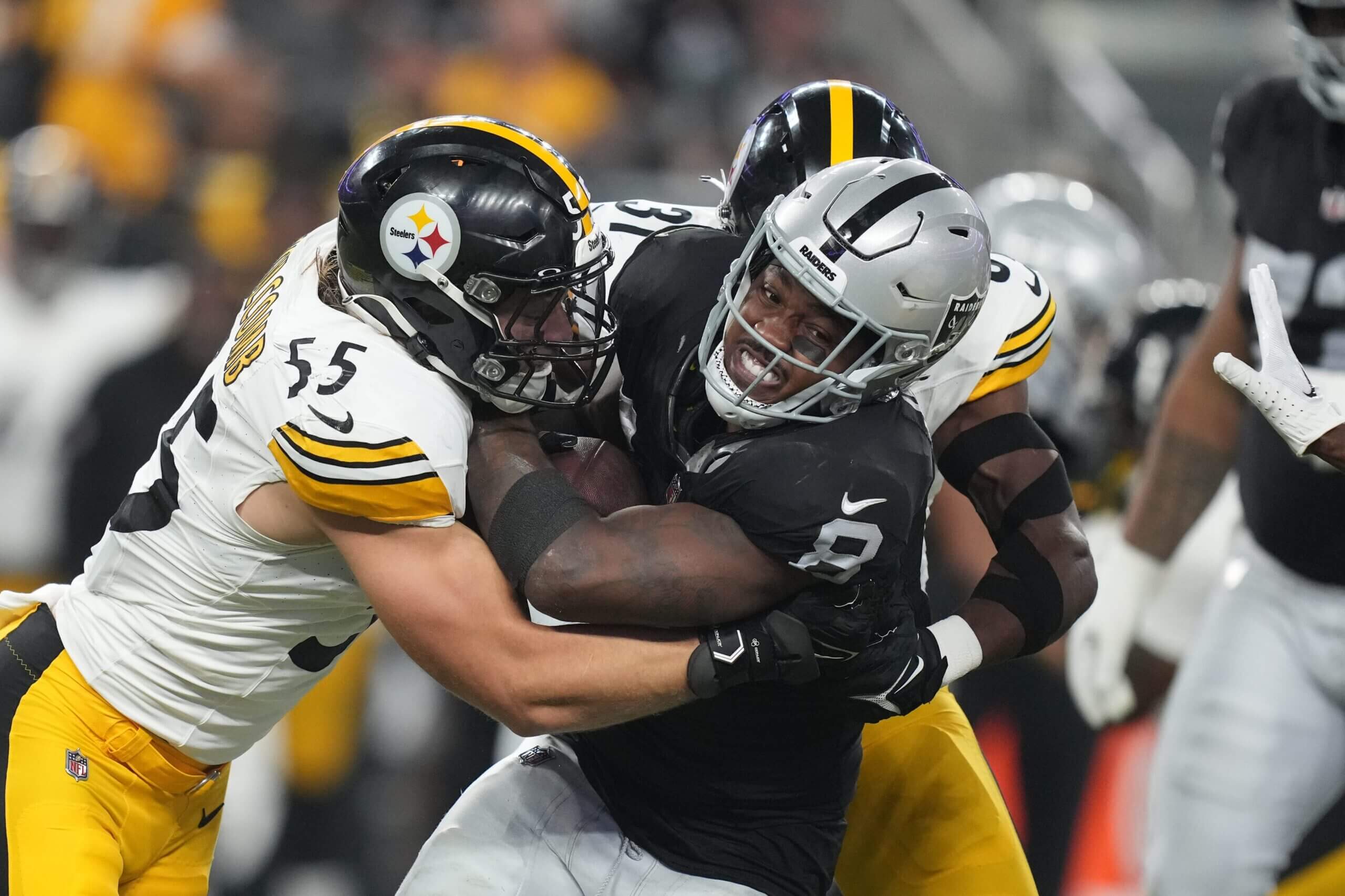 Sep 24, 2023; Paradise, Nevada, USA; Las Vegas Raiders running back Josh Jacobs (8) is tackled by Pittsburgh Steelers linebacker Cole Holcomb (55) in the first half at Allegiant Stadium. Mandatory Credit: Kirby Lee-USA TODAY Sports