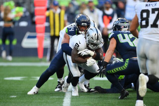 Aug 7, 2025; Seattle, Washington, USA; Seattle Seahawks defensive end Mike Morris (94) tackles Las Vegas Raiders running back Ashton Jeanty (2)during the first half at Lumen Field. Mandatory Credit: Steven Bisig-Imagn Images Ashton Jeanty, Raiders